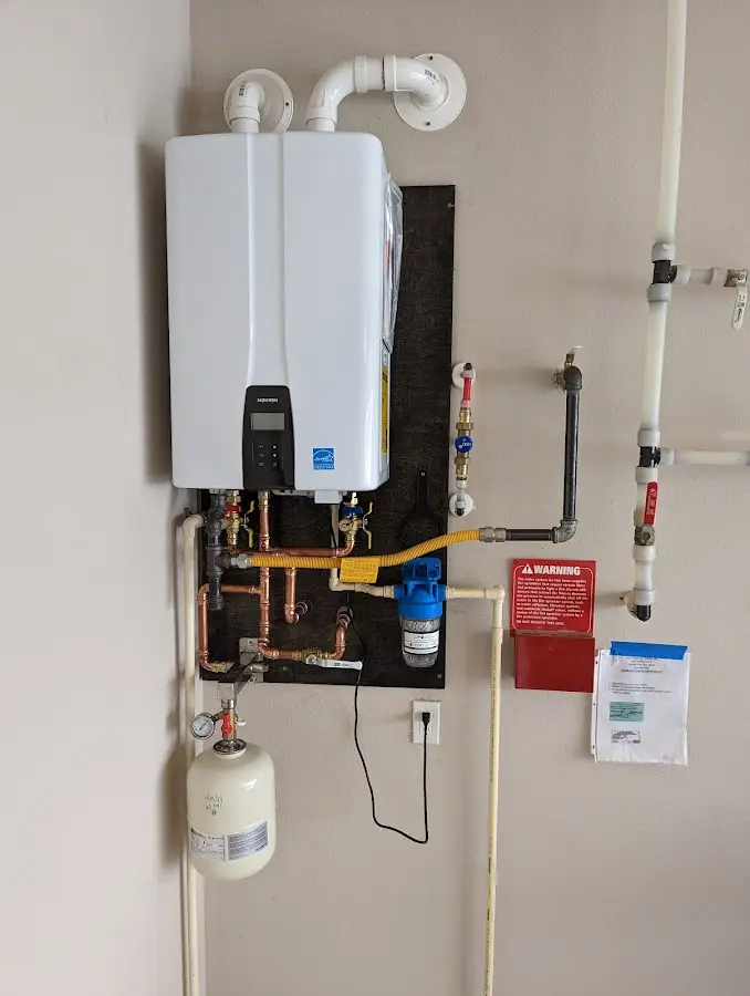 Professional plumber installing copper piping in a Oak Hill home